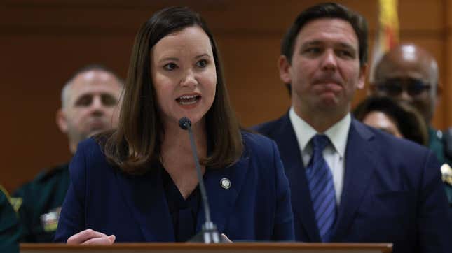 Florida Gov. Ron DeSantis listens as Florida Attorney General Ashley Moody speaks during a press conference in 2022. 